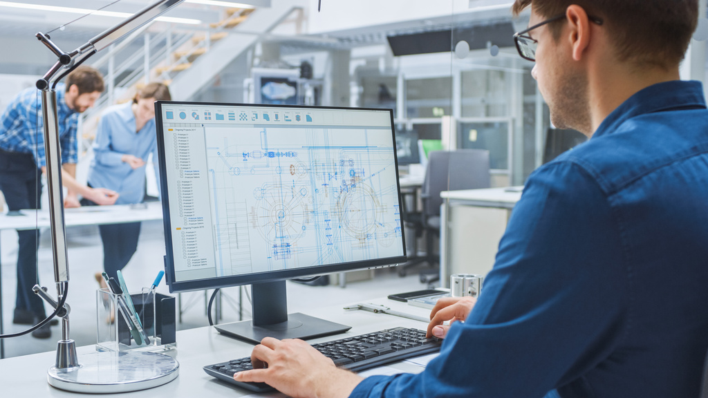 Man using computer in a design/ office setting